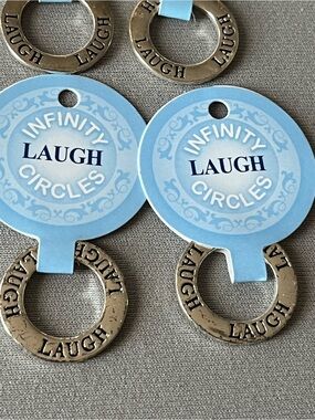 NWT nine infinity circles imprinted with laugh. Layered in sterling silver.